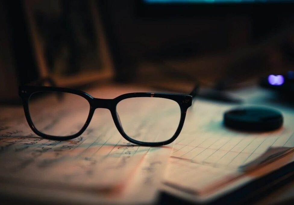 Spectacles atop handwritten notes